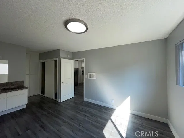 a view of empty room with wooden floor and window
