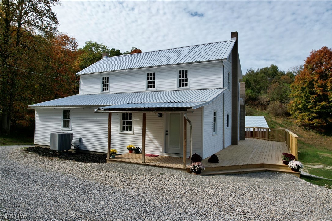 9734 Edwards Ridge Road Southeast Uhrichsville, OH 44683 - Photo 2 of 35 View of front of house featuring central air condition unit and a deck