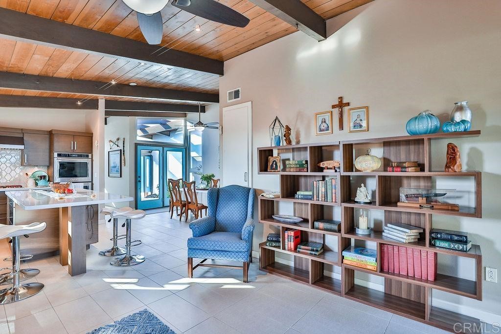 3573 Chasewood Drive San Diego, CA 92111 - Photo 16 of 57 a living room with lots of furniture and a book shelf