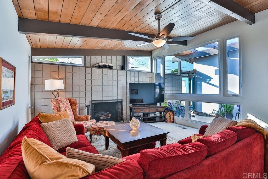 3573 Chasewood Drive San Diego, CA 92111 - Photo 17 of 57 a living room with furniture a fireplace and a large window