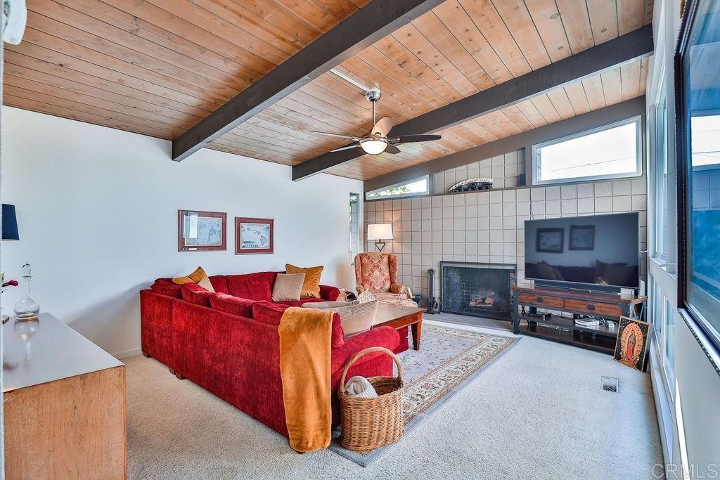 3573 Chasewood Drive San Diego, CA 92111 - Photo 18 of 57 a living room with furniture a flat screen tv and a fireplace