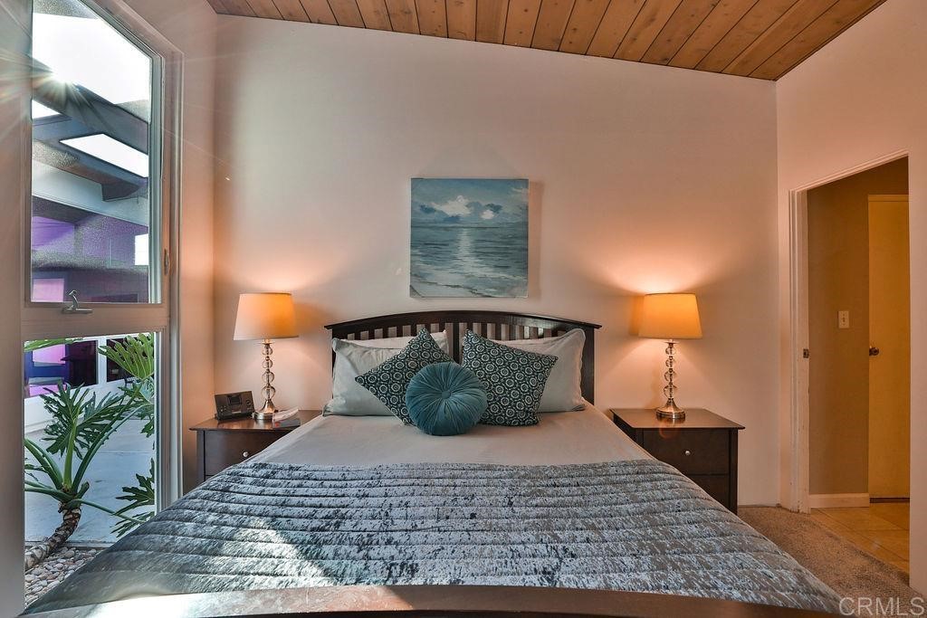 3573 Chasewood Drive San Diego, CA 92111 - Photo 21 of 57 a bedroom with a bed and a potted plant