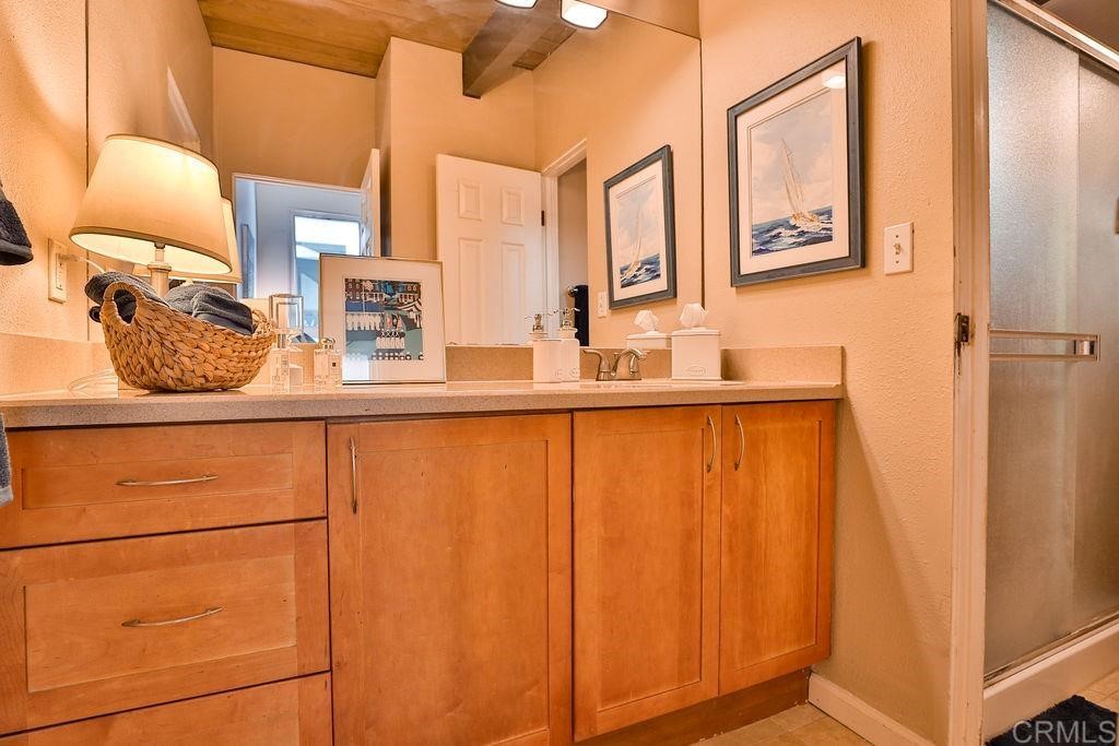 3573 Chasewood Drive San Diego, CA 92111 - Photo 26 of 57 a bathroom with a sink and a mirror