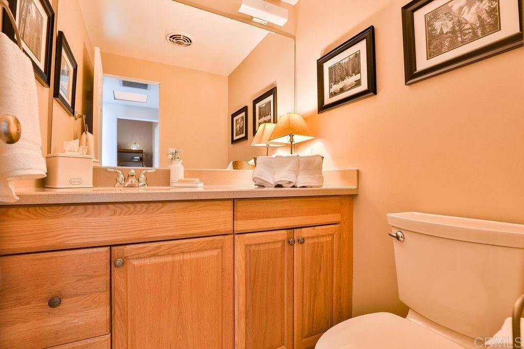 3573 Chasewood Drive San Diego, CA 92111 - Photo 27 of 57 a bathroom with a toilet sink and mirror