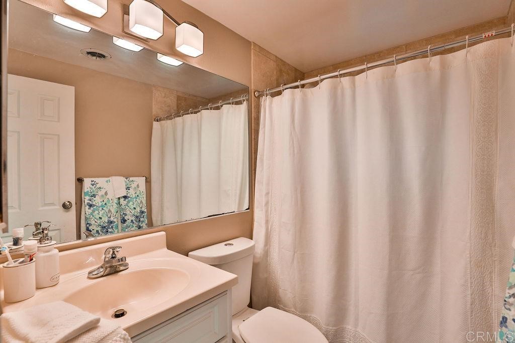 3573 Chasewood Drive San Diego, CA 92111 - Photo 29 of 57 a bathroom with a sink and a mirror