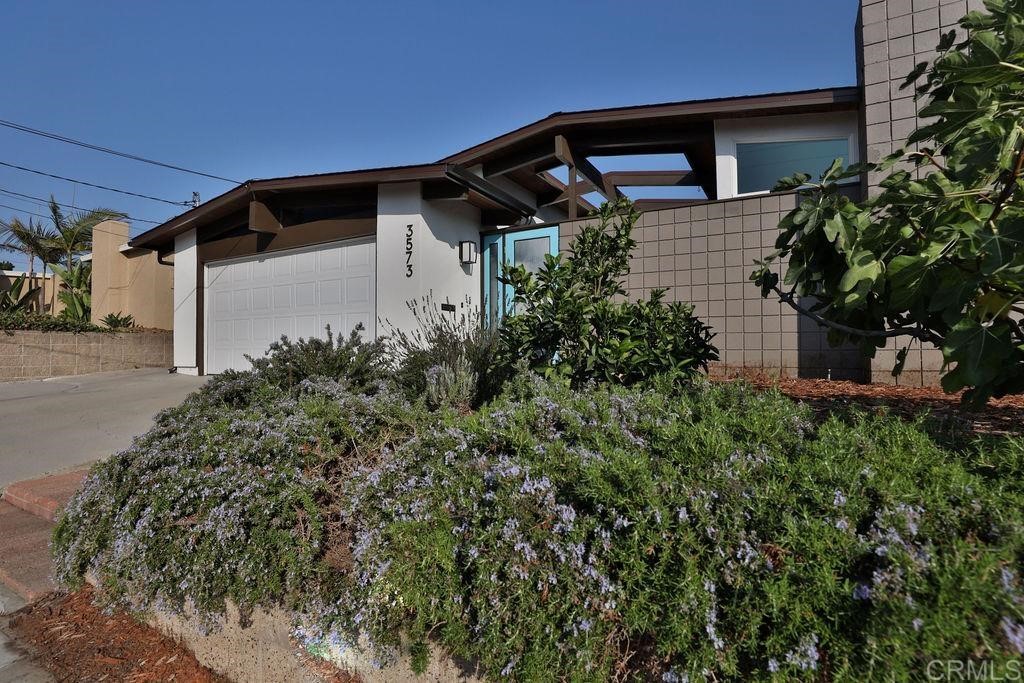 3573 Chasewood Drive San Diego, CA 92111 - Photo 53 of 57 a front view of a house with garden