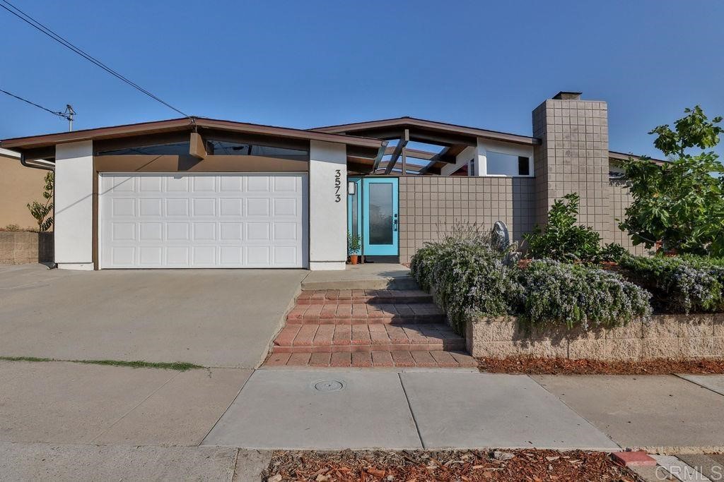 3573 Chasewood Drive San Diego, CA 92111 - Photo 54 of 57 a front view of a house with garden