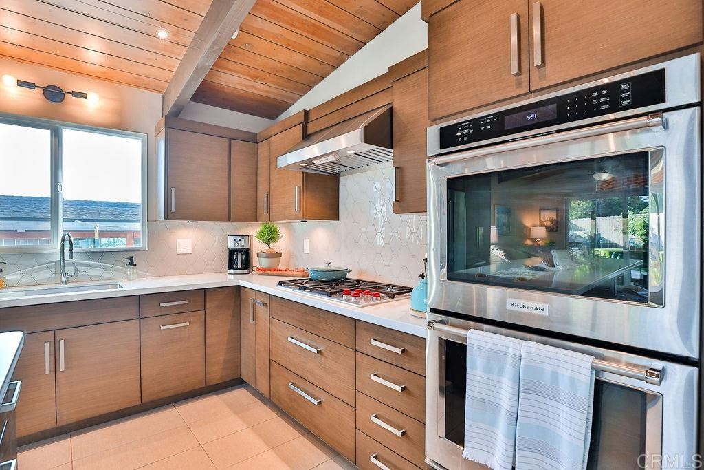 3573 Chasewood Drive San Diego, CA 92111 - Photo 6 of 57 a kitchen with a sink stove and cabinets