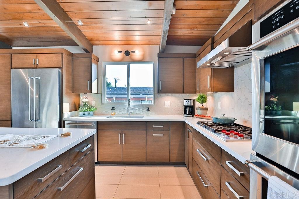 3573 Chasewood Drive San Diego, CA 92111 - Photo 8 of 57 a kitchen with stainless steel appliances granite countertop a sink stove and refrigerator