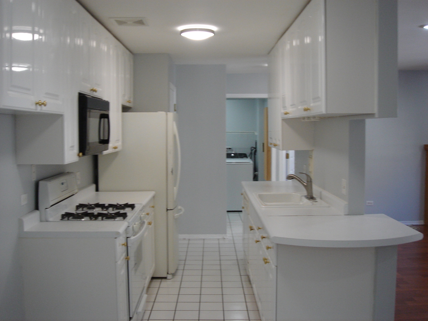 5420 North Sheridan Road, Unit 408 Chicago, IL 60640 - Photo 11 of 17 a kitchen with stainless steel appliances a sink stove and refrigerator