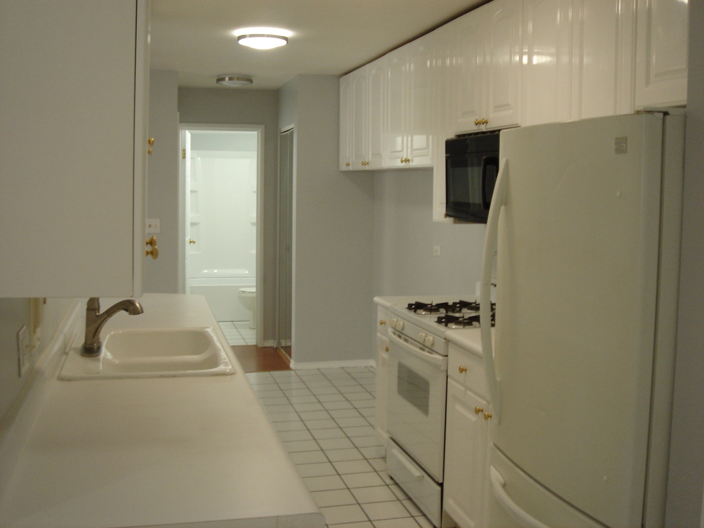 5420 North Sheridan Road, Unit 408 Chicago, IL 60640 - Photo 12 of 17 a bathroom with a sink a faucet a washer and dryer