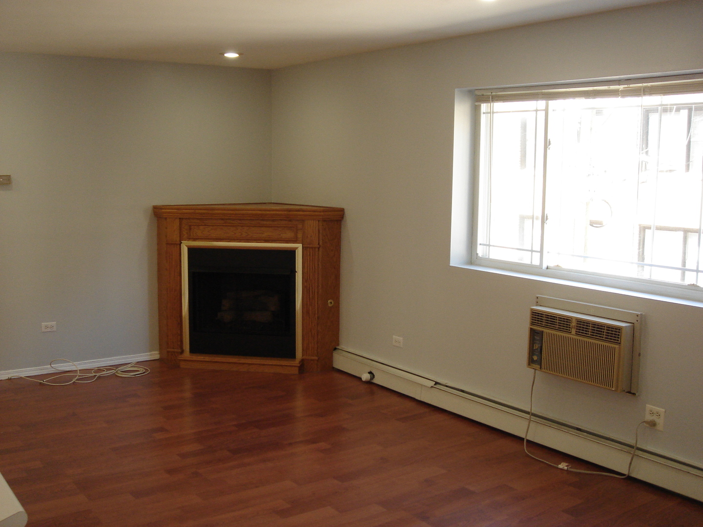 5420 North Sheridan Road, Unit 408 Chicago, IL 60640 - Photo 9 of 17 an empty room with windows and fireplace