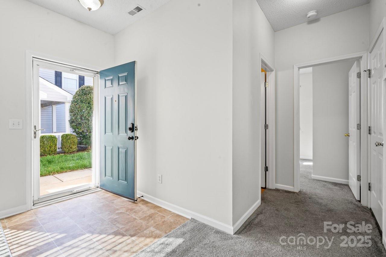 8663 Meadowmont View Drive Charlotte, NC 28269 - Photo 13 of 30 a view of an empty room with glass door and a window