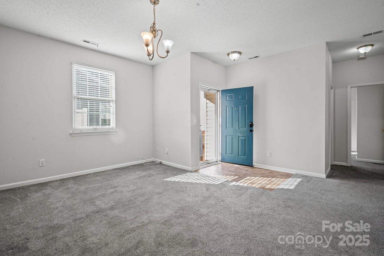 8663 Meadowmont View Drive Charlotte, NC 28269 - Photo 14 of 30 an empty room with windows and entrance