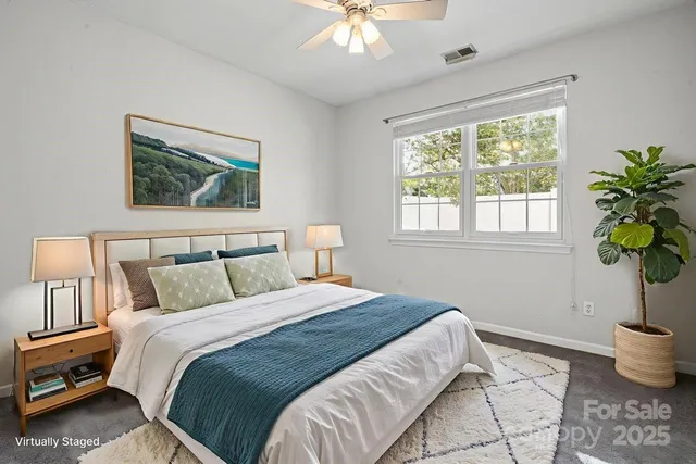 a bed sitting in a bedroom next to a window