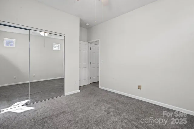 a view of a room with a shower and closet