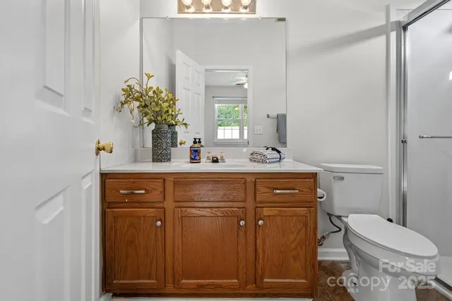 a bathroom with a sink a toilet and mirror