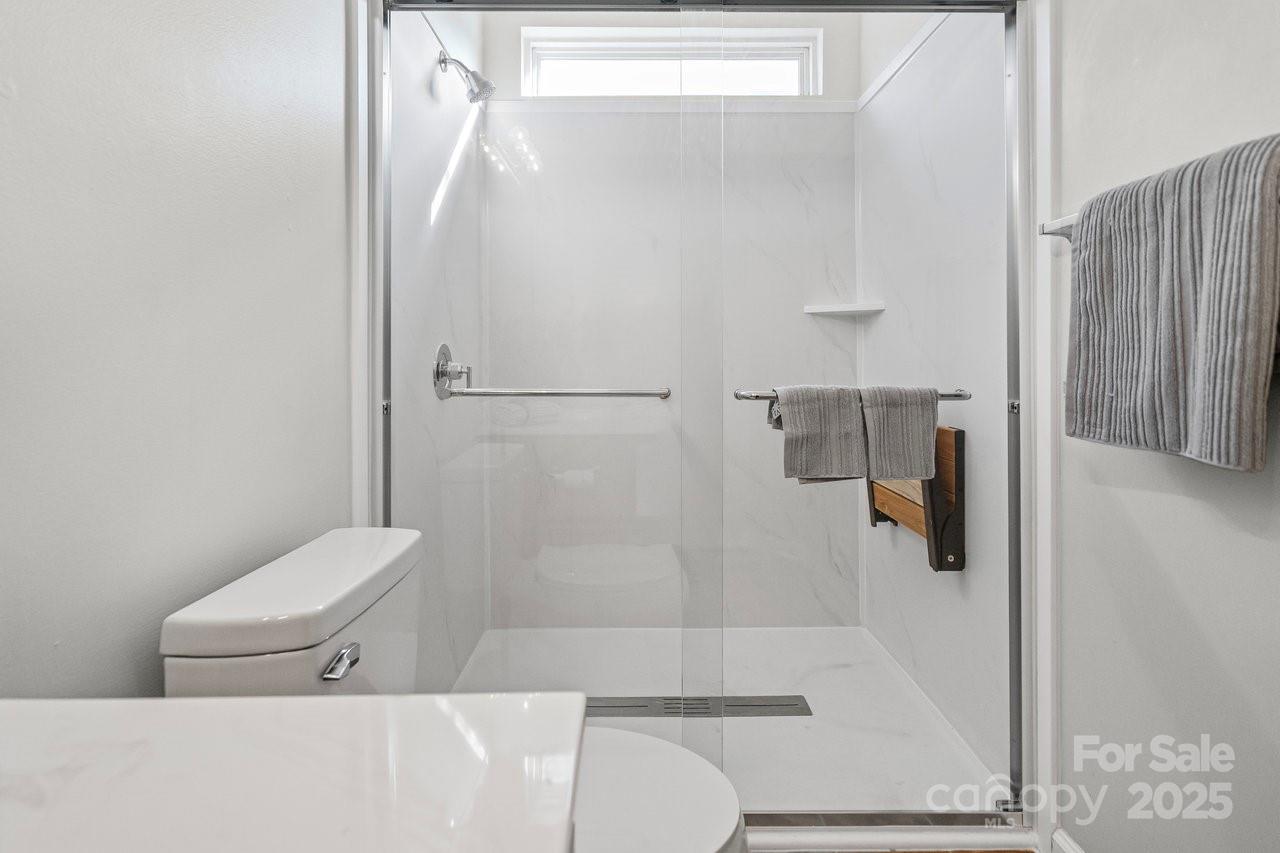 8663 Meadowmont View Drive Charlotte, NC 28269 - Photo 20 of 30 a bathroom with a shower and toilet