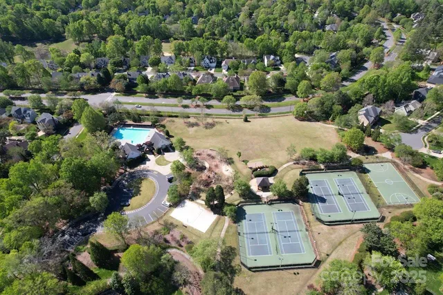 an aerial view of a houses with yard