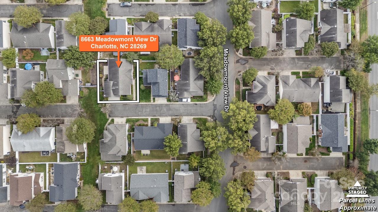 8663 Meadowmont View Drive Charlotte, NC 28269 - Photo 4 of 30 an aerial view of multi story residential apartment building with parking