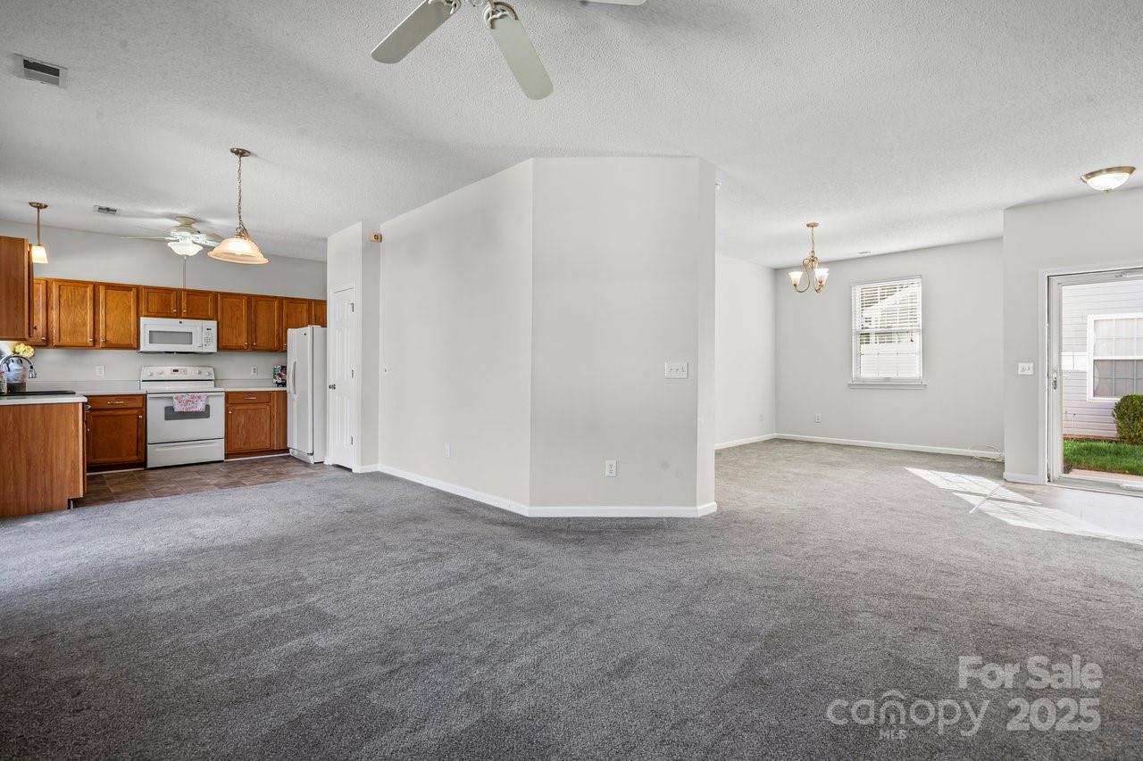8663 Meadowmont View Drive Charlotte, NC 28269 - Photo 7 of 30 a view of a kitchen with a sink stove cabinets and empty room