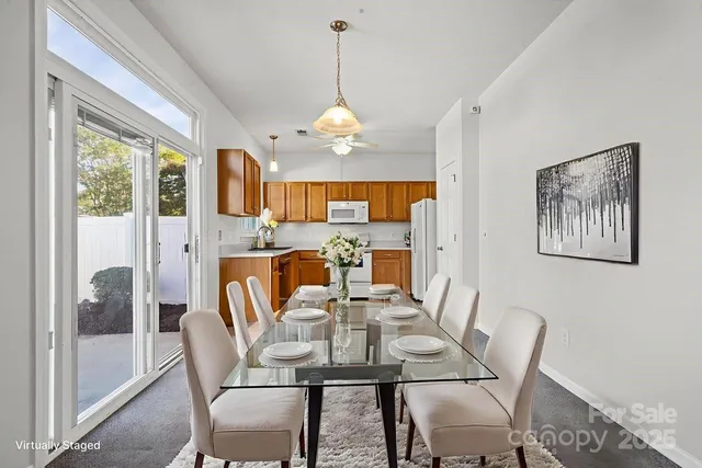 a view of a dining room with furniture large window and wooden floor