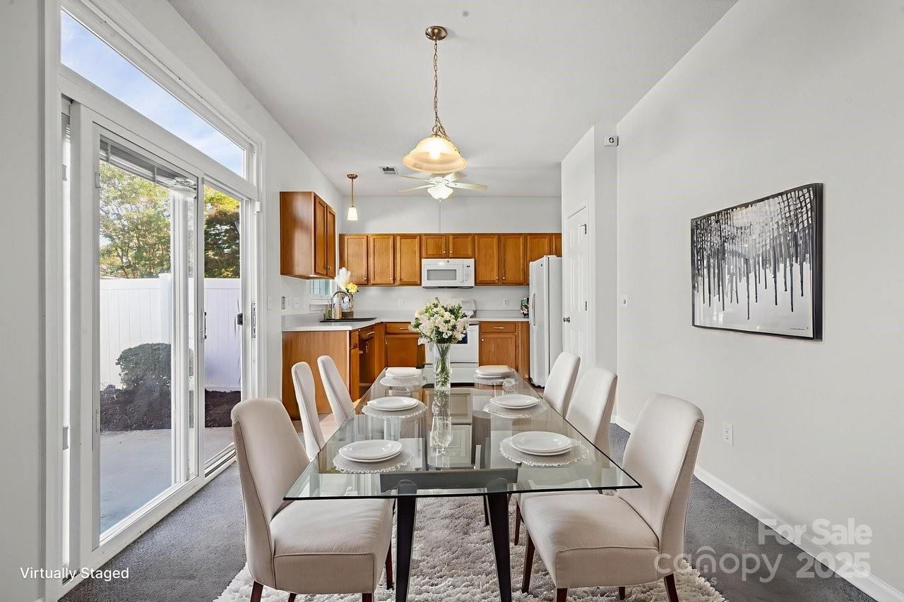 8663 Meadowmont View Drive Charlotte, NC 28269 - Photo 10 of 30 a view of a dining room with furniture large window and wooden floor