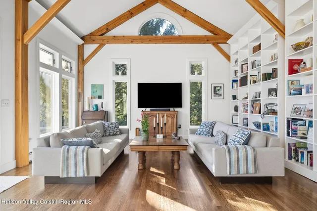 a living room with furniture a rug and a painting on the wall