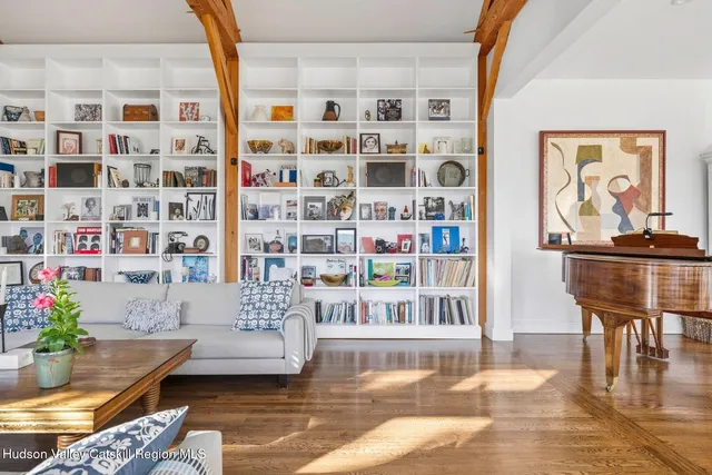 a view of a hallway with entryway wooden floor and a fireplace
