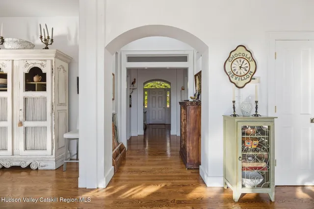 a bedroom with a bed and large windows