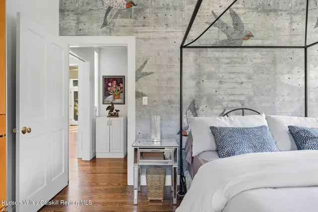 a bed room with a bed and a chair