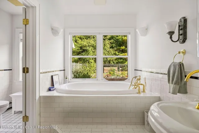 a bedroom with a bed and a large window with outer view