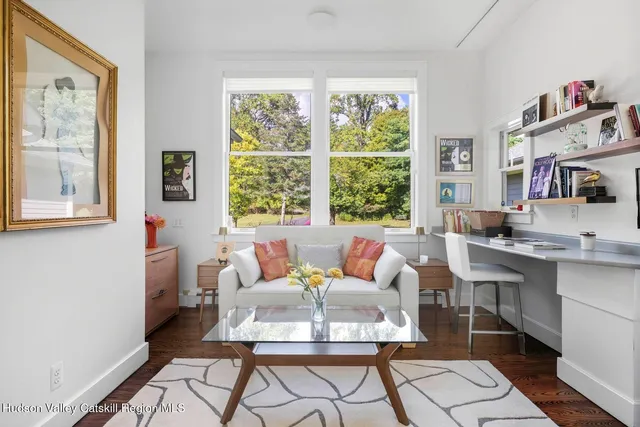a view of a workspace with furniture and a lounge chair
