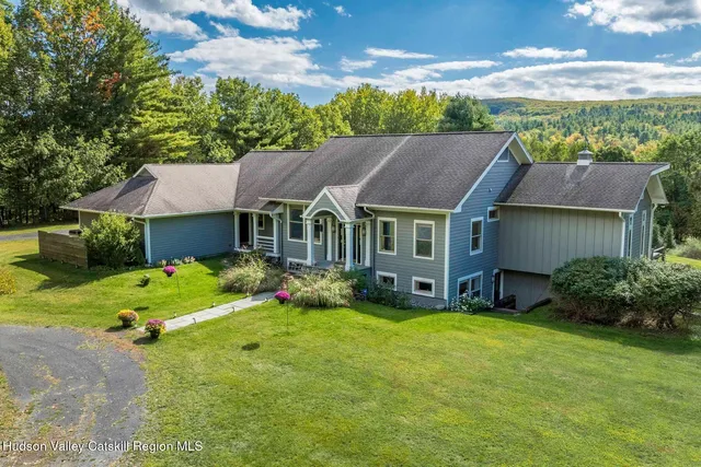 a view of a house with pool and sitting area