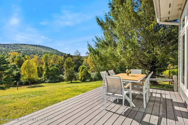 a picture of a room with a white wall and a large window