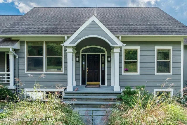 a dining room with stainless steel appliances granite countertop a stove and chairs with wooden floor