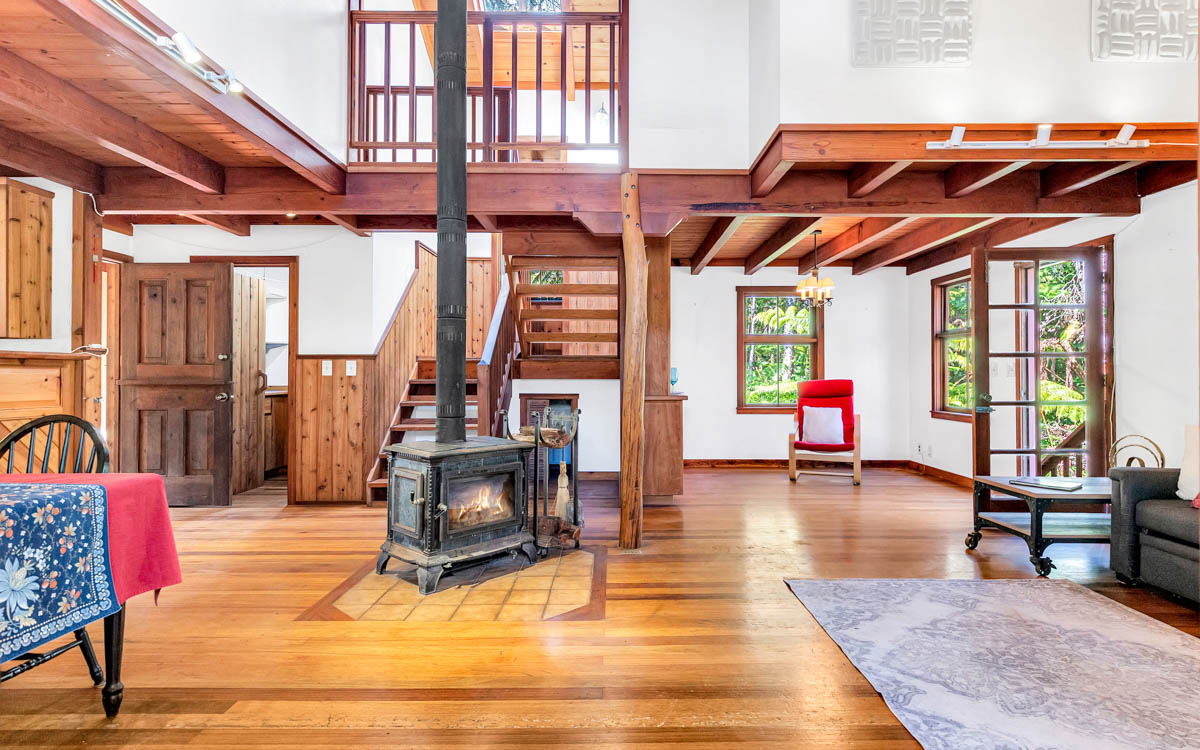 19-3976 John A Lee Road Volcano, HI 96785 - Photo 12 of 30 a living room with furniture a wooden floor and a fireplace