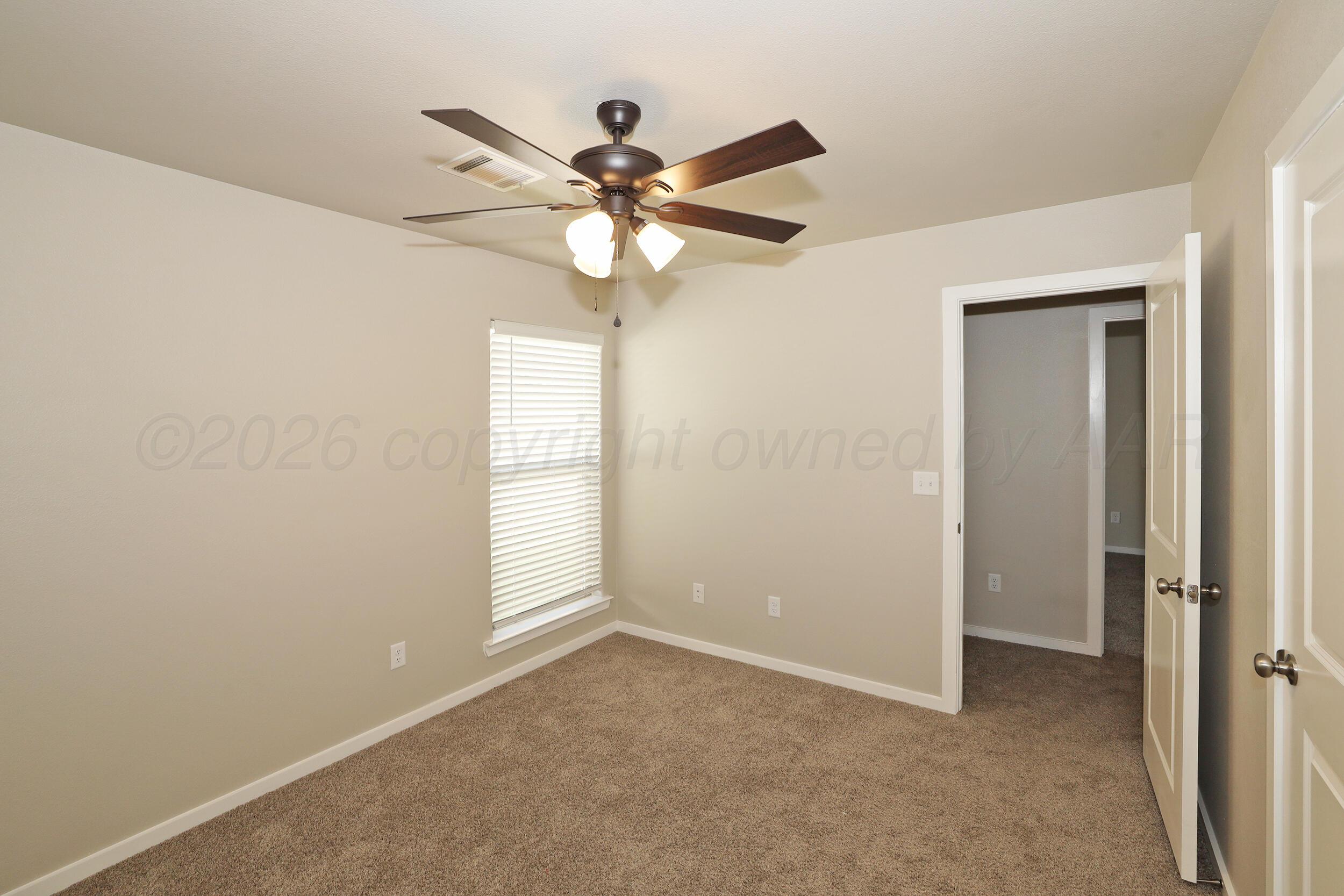 7205 Athens Street Amarillo, TX 79118 - Photo 12 of 25 a view of an empty room with a window