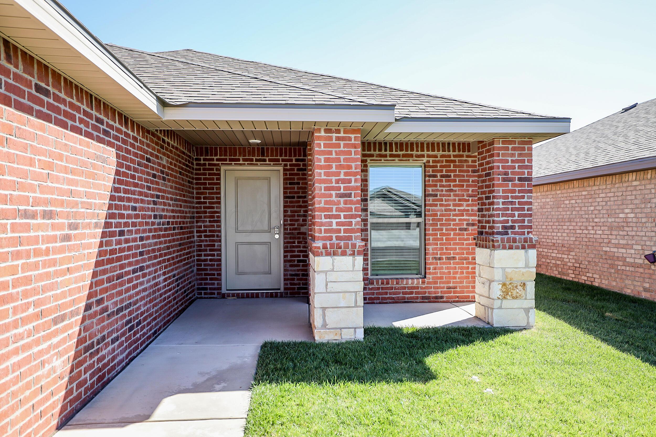 7205 Athens Street Amarillo, TX 79118 - Photo 2 of 25 a front view of a house with a yard