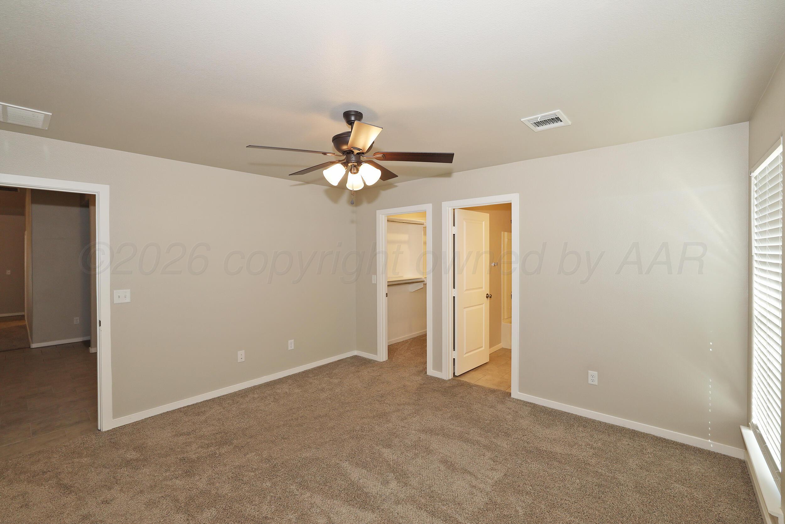 7205 Athens Street Amarillo, TX 79118 - Photo 23 of 25 a view of an empty room with a chandelier fan