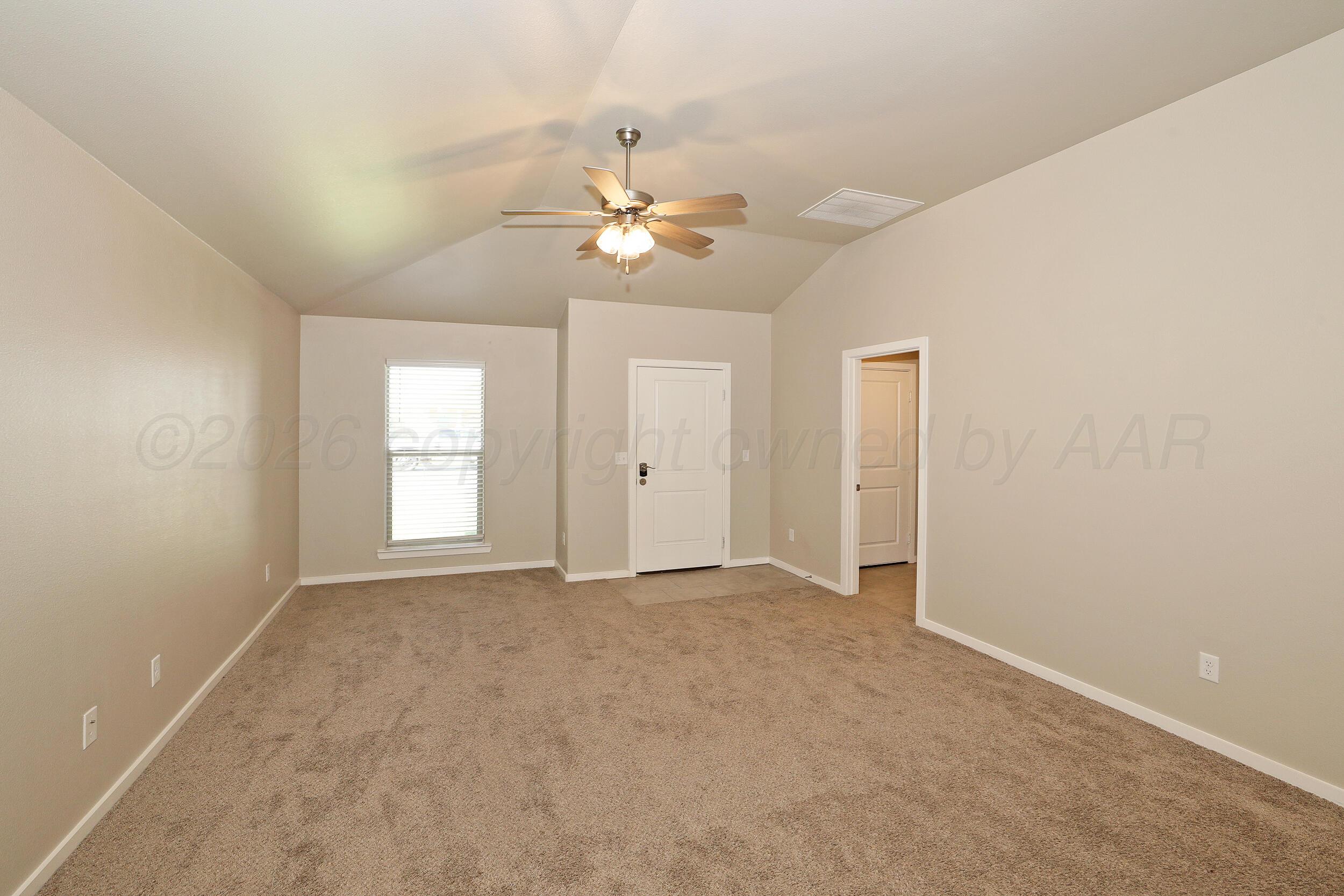 7205 Athens Street Amarillo, TX 79118 - Photo 3 of 25 an empty room with windows and fan