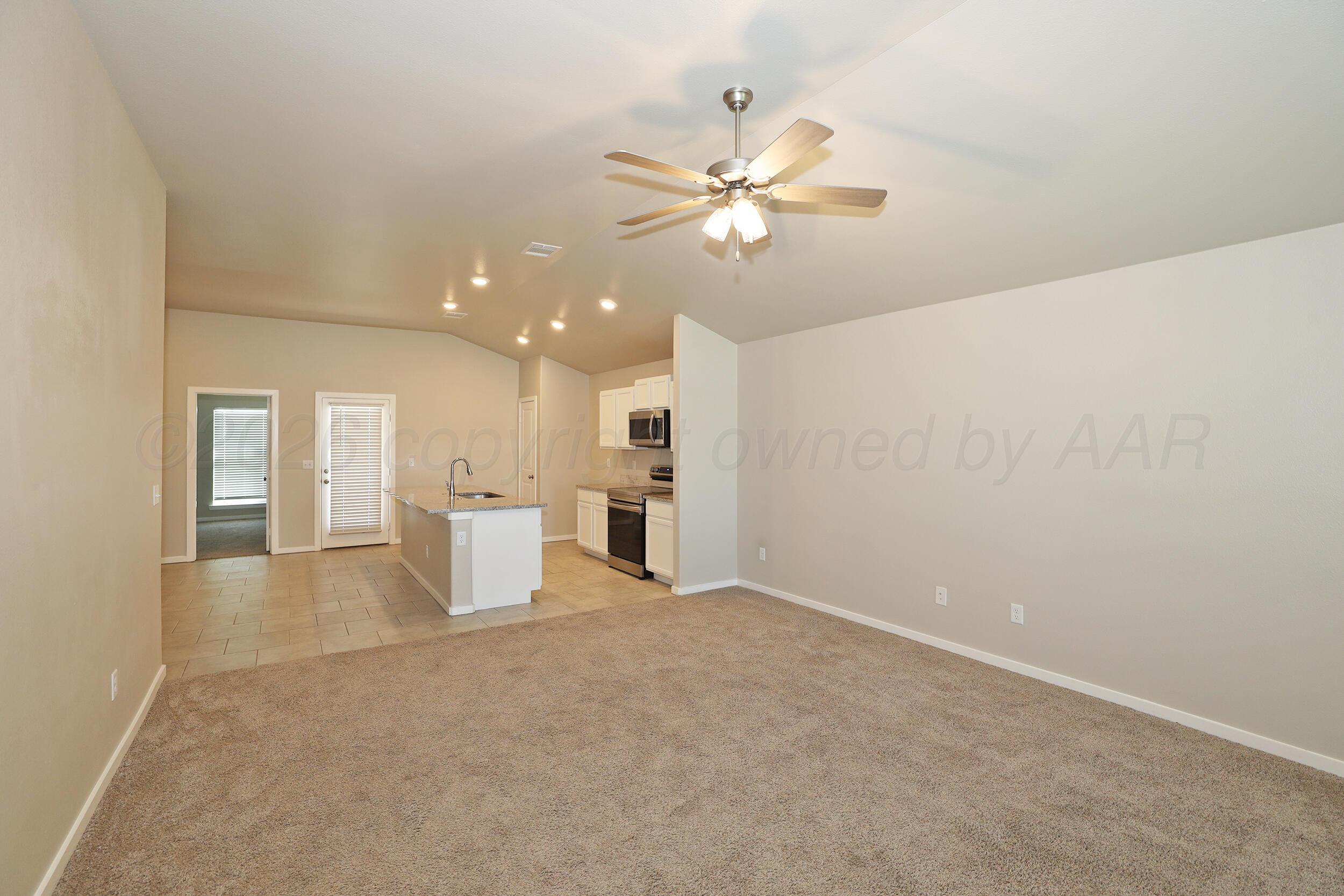 7205 Athens Street Amarillo, TX 79118 - Photo 5 of 25 a view of a livingroom with a ceiling fan and entryway