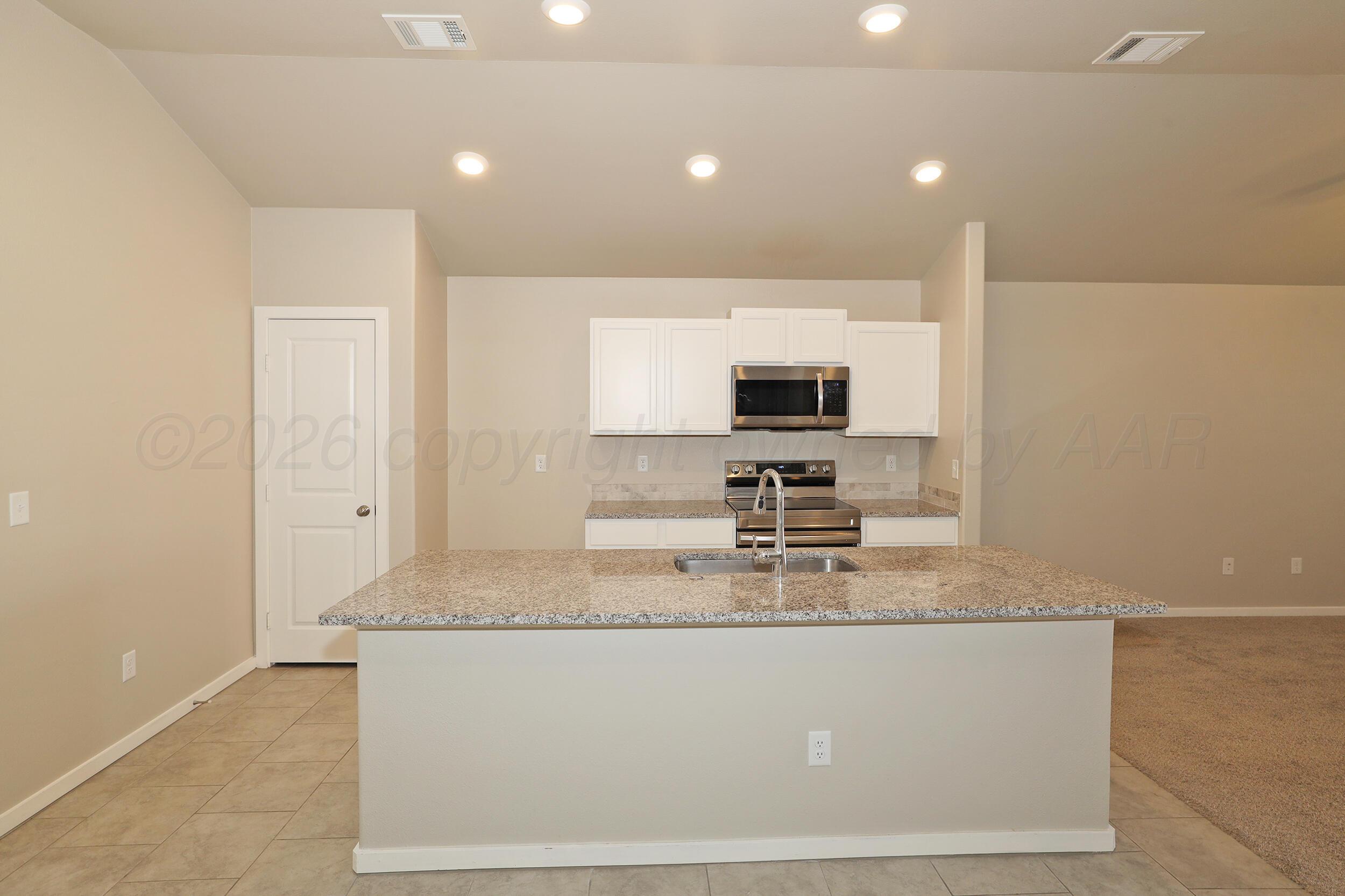 7205 Athens Street Amarillo, TX 79118 - Photo 7 of 25 a bathroom with sink granite and mirror