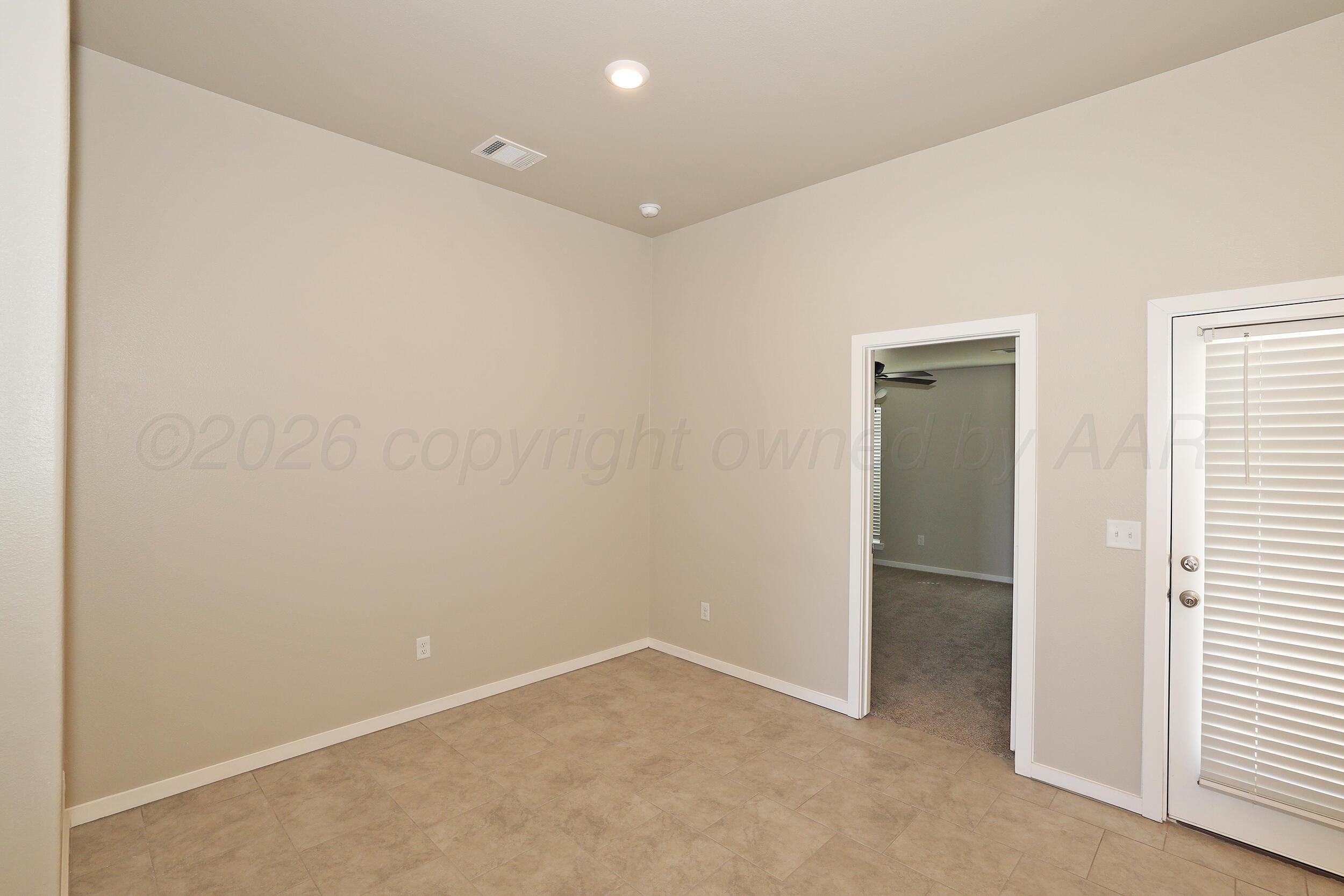 7205 Athens Street Amarillo, TX 79118 - Photo 10 of 25 an empty room with windows