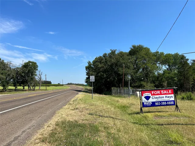 a street sign on a sidewalk next to a road