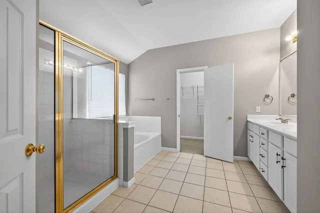 a bathroom with a glass door shower a sink and a mirror