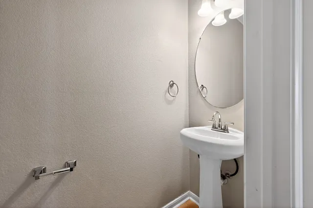 a bathroom with a sink a mirror and vanity