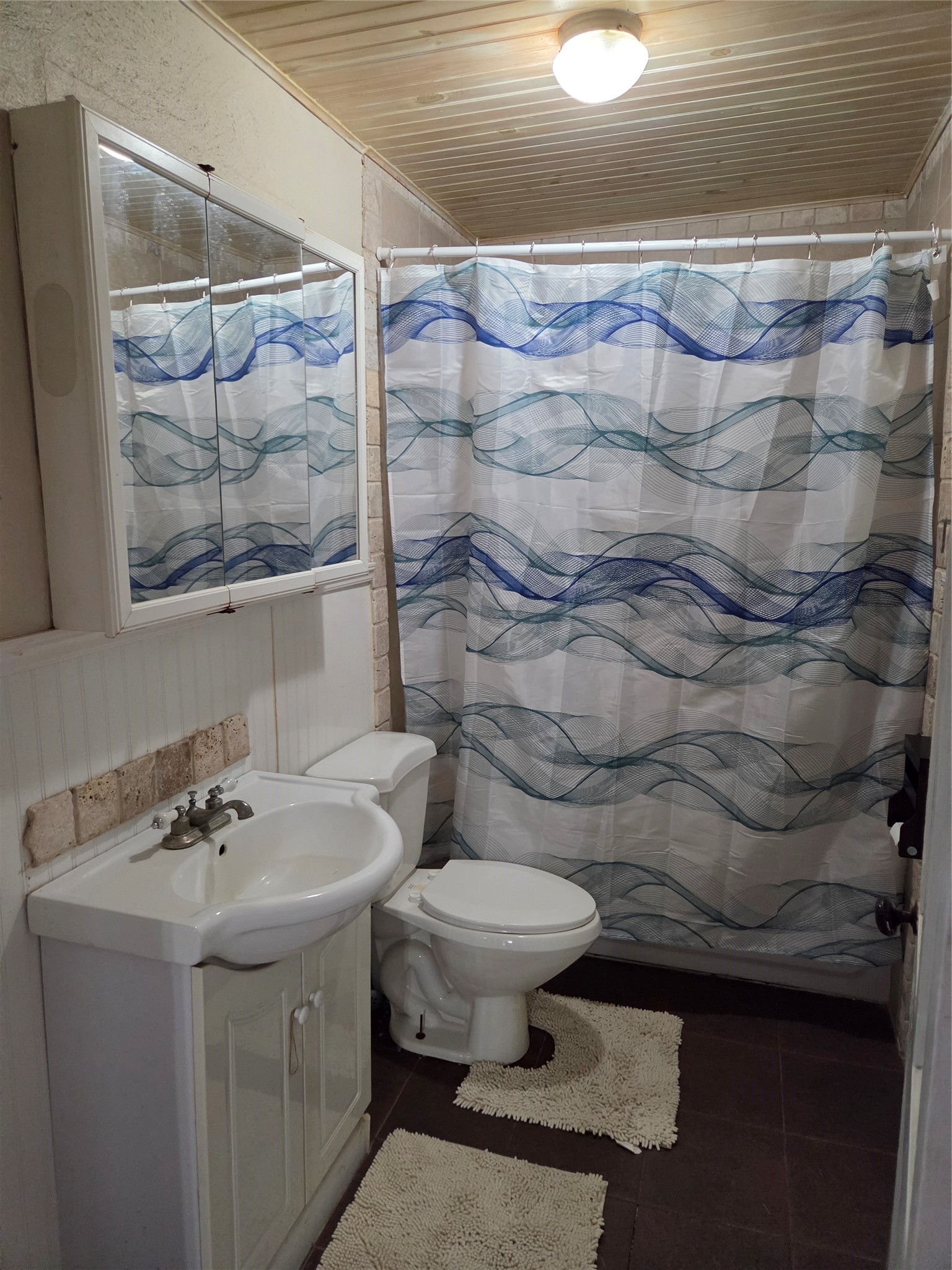 4910 FM 3012 Road Wharton, TX 77488 - Photo 20 of 21 Modern second bathroom featuring a full-size bathtub with a shower surround, neutral finishes, and efficient lighting, perfect for guest use or family convenience.