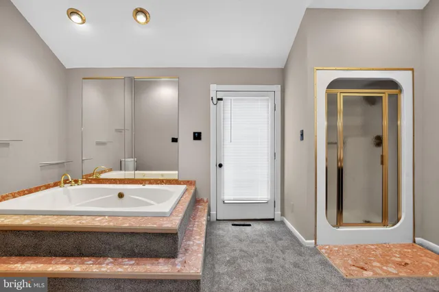 a spacious bathroom with a granite countertop sink and a mirror