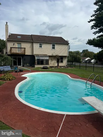 a view of a swimming pool with a yard